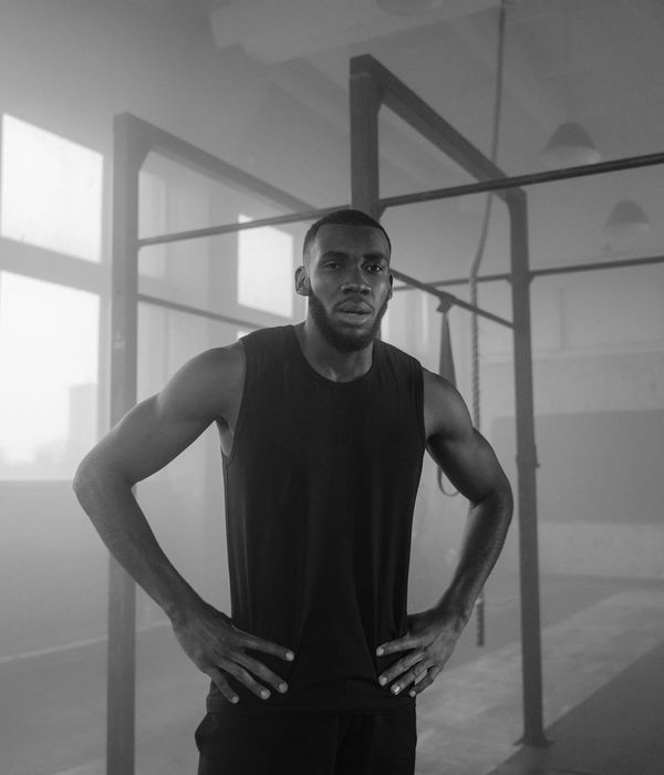 A man performing strength training in a modern minimalist gym.